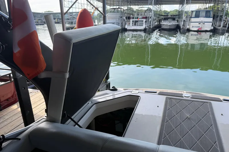 Slide: The Image of 2013 Regal 2100 Bowrider with open storage compartment at marina dock. - 21