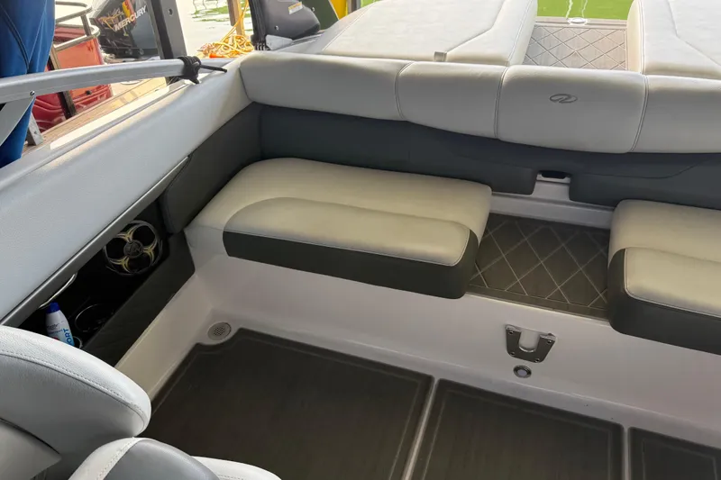 Slide: The Image of Interior seating of a 2013 Regal 2100 Bowrider boat, featuring cushioned seats. - 23