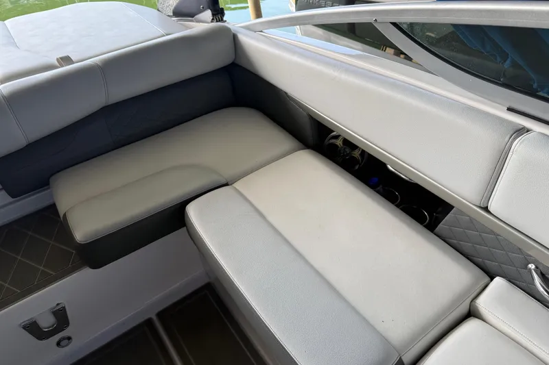 Slide: The Image of 2013 Regal 2100 Bowrider interior seating with gray upholstery and cup holders. - 24