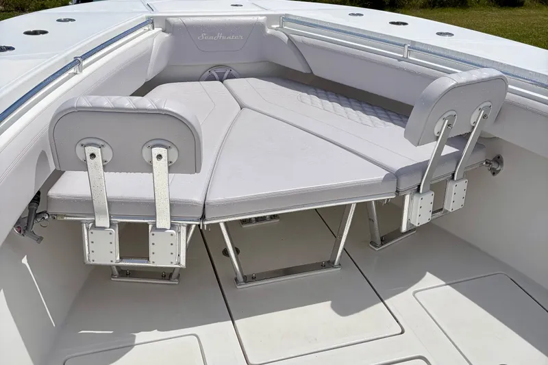 Slide: The Image of 2024 SeaHunter 31 Tournament boat interior with cushioned seating and stainless steel fixtures. - 10