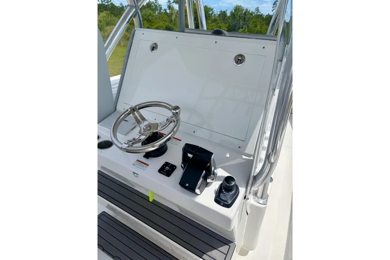 Slide: The Image of 2024 SeaHunter 31 Tournament boat helm with steering wheel and controls. - 15