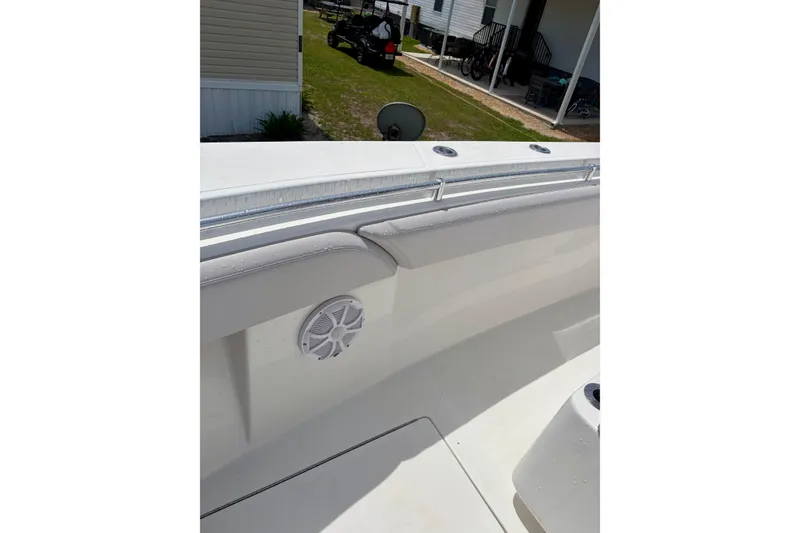Slide: The Image of 2024 SeaHunter 31 Tournament boat interior with speaker and cushioned seating. - 20