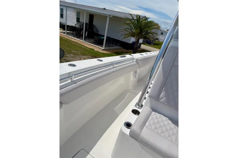 Slide: The Image of 2024 SeaHunter 31 Tournament boat interior with quilted seating and rod holders. - 21