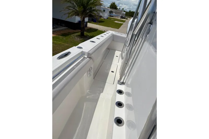 Slide: The Image of 2024 SeaHunter 31 Tournament boat deck with rod holders and sleek design. - 22