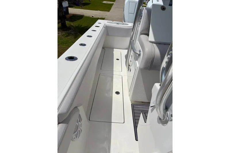 Slide: The Image of 2024 SeaHunter 31 Tournament boat deck with rod holders and seating. - 23