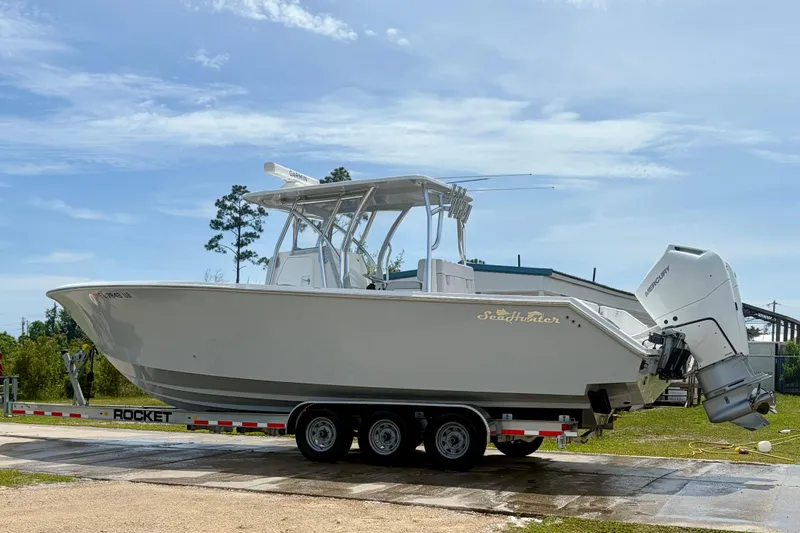 Slide: The Image of 2024 SeaHunter 31 Tournament boat on trailer, featuring dual Mercury outboard engines. - 3
