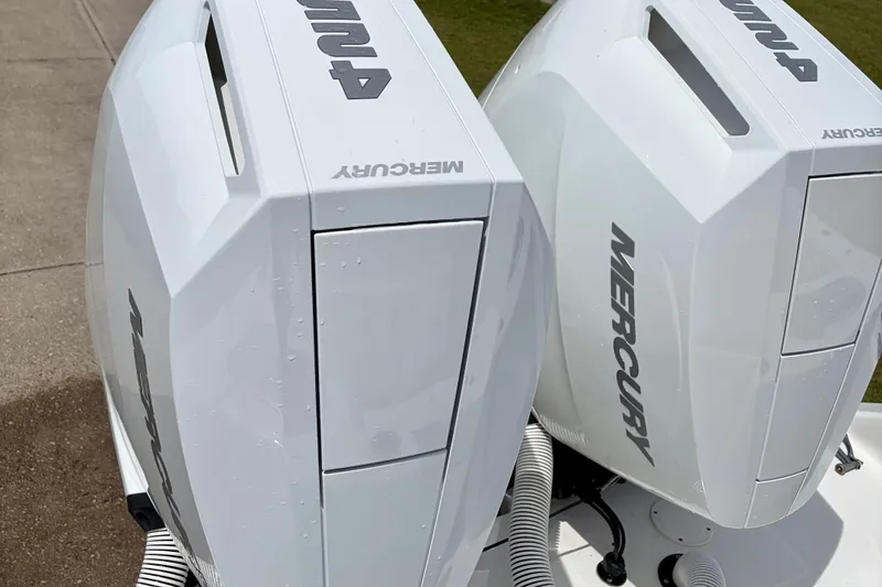 Slide: The Image of Twin Mercury outboard engines on a 2024 SeaHunter 31 Tournament boat. - 31