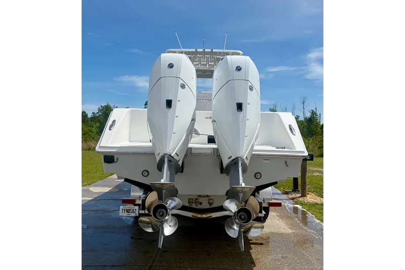 Slide: The Image of 2024 SeaHunter 31 Tournament boat with dual outboard engines, rear view. - 4