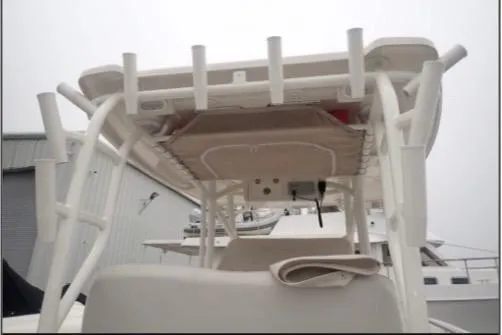Slide: The Image of 2022 Sailfish 320 CC boat with rod holders and canopy, viewed from the rear. - 11