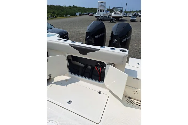 Slide: The Image of 2022 Sailfish 320 CC boat with open storage compartment and dual Mercury engines. - 4