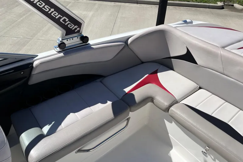 Slide: The Image of 2007 MasterCraft X-15 boat interior with gray and red seating, showcasing luxury design. - 15
