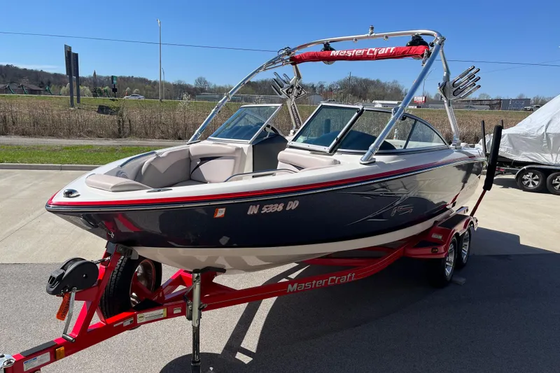 Slide: The Image of 2007 MasterCraft X-15 boat on trailer, parked outdoors under clear blue sky. - 4