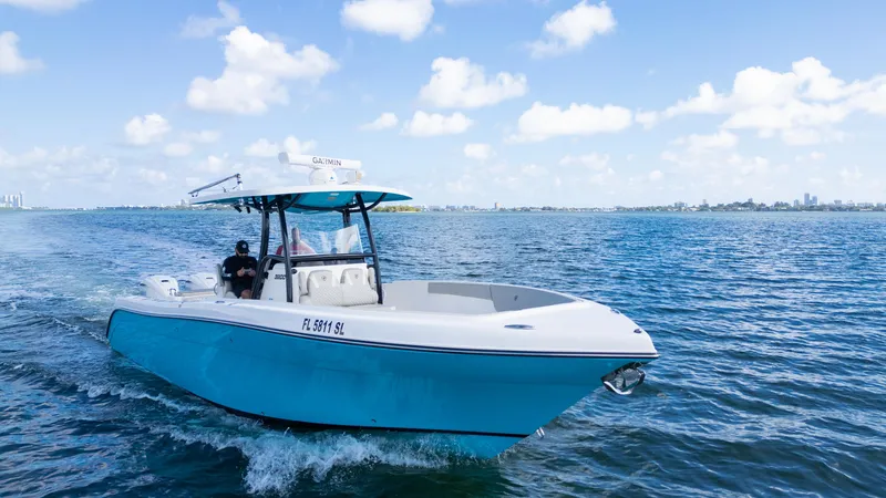 The Image of Century 3200 Center Console 2019 boat cruising on open water under a clear blue sky. - 0