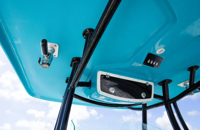 Slide: The Image of 2019 Century 3200 Center Console boat's blue overhead console with storage and controls. - 15