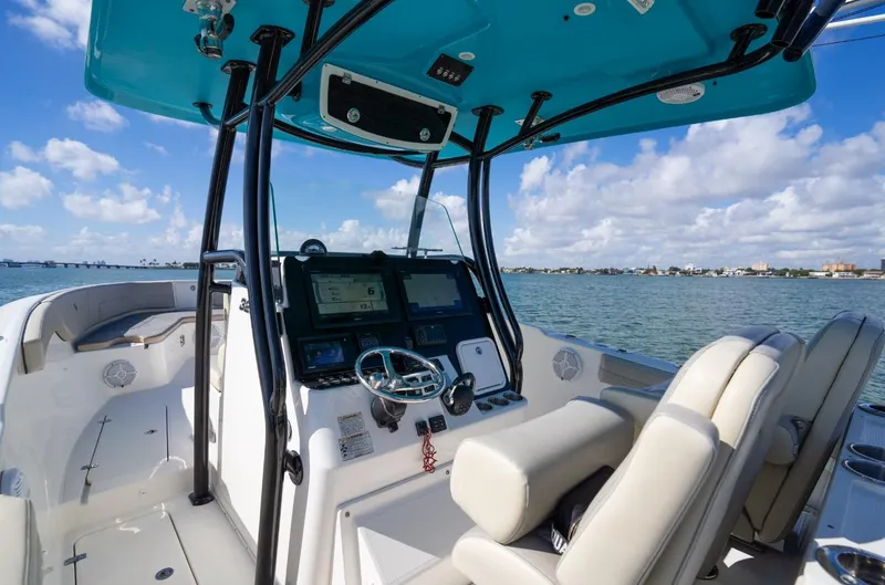 Slide: The Image of 2019 Century 3200 Center Console boat interior with dual seats and navigation system on open water. - 17