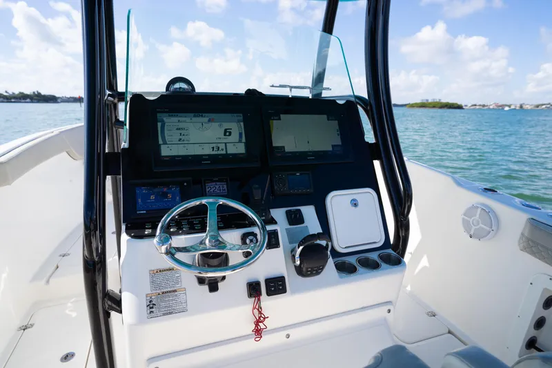 Slide: The Image of 2019 Century 3200 Center Console boat dashboard with steering wheel and navigation screens. - 18