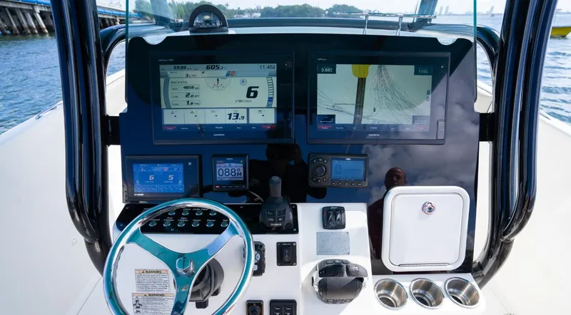 Slide: The Image of 2019 Century 3200 Center Console boat dashboard with advanced navigation and control systems. - 19