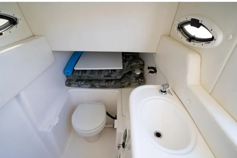 Slide: The Image of 2019 Century 3200 Center Console boat interior with toilet and sink. - 26