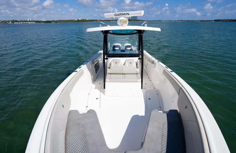 Slide: The Image of 2019 Century 3200 Center Console boat on open water, featuring Garmin equipment. - 29