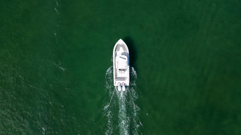 Slide: The Image of Aerial view of 2019 Century 3200 Center Console boat cruising on green water. - 3