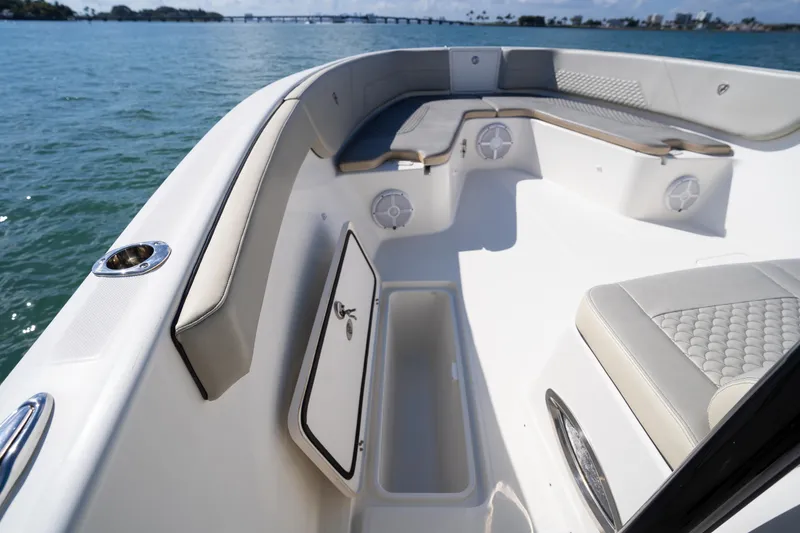 Slide: The Image of 2019 Century 3200 Center Console boat interior with seating and storage, on calm water. - 30