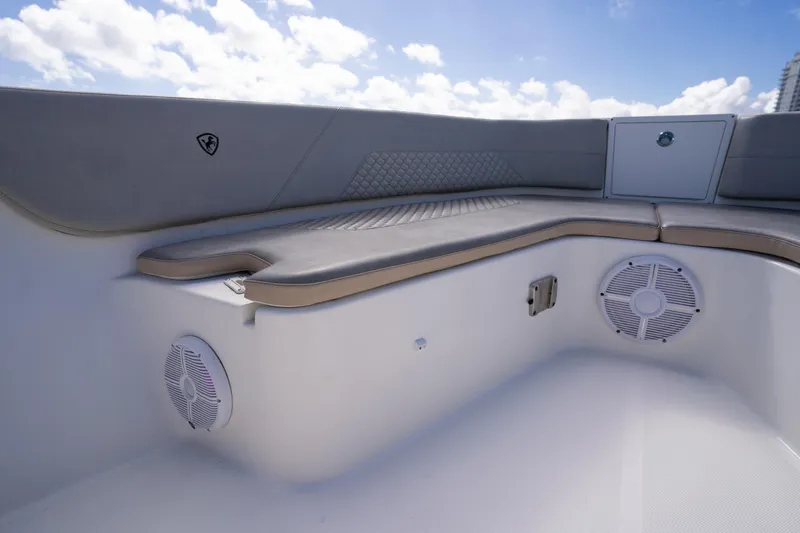 Slide: The Image of 2019 Century 3200 Center Console boat interior with cushioned seating and speakers. - 32
