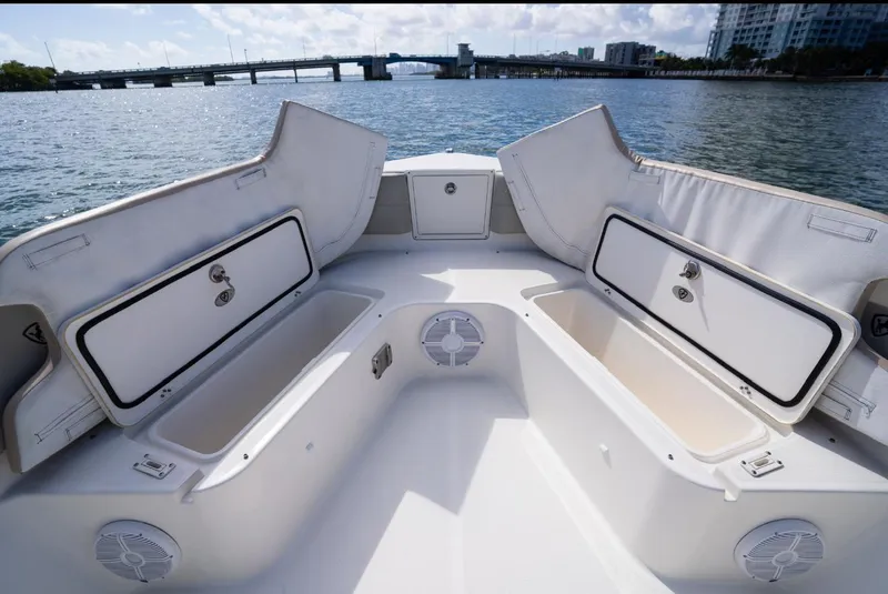 Slide: The Image of 2019 Century 3200 Center Console boat with open storage compartments on a sunny day. - 33