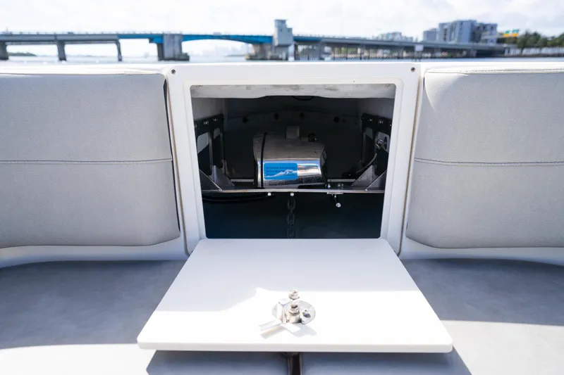 Slide: The Image of 2019 Century 3200 Center Console boat interior with open storage compartment and table. - 34
