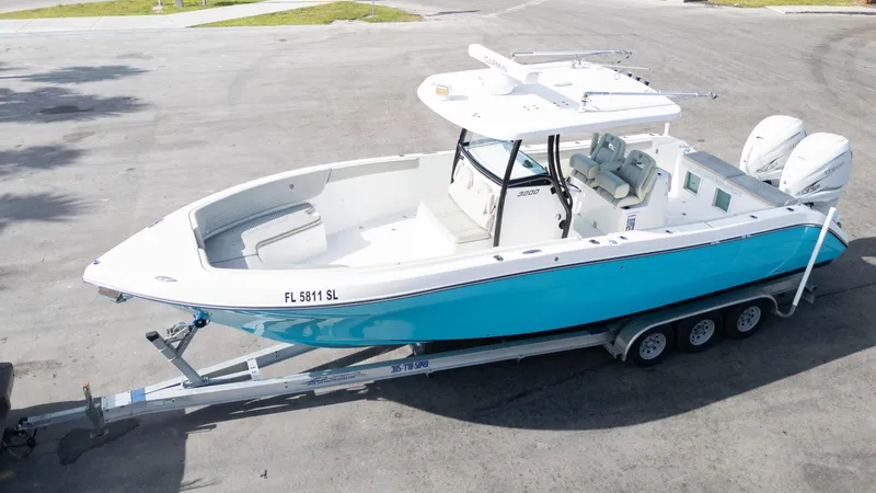 Slide: The Image of 2019 Century 3200 Center Console boat on trailer, featuring a sleek blue and white design. - 35