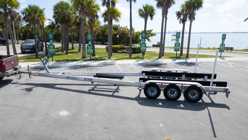 Slide: The Image of Trailer for 2019 Century 3200 Center Console boat, parked near palm trees by the water. - 39
