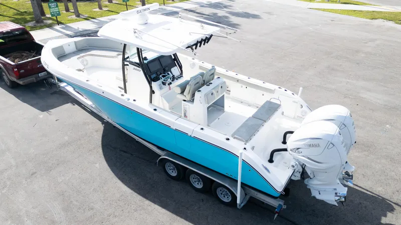 Slide: The Image of 2019 Century 3200 Center Console boat on trailer, featuring dual outboard engines. - 41
