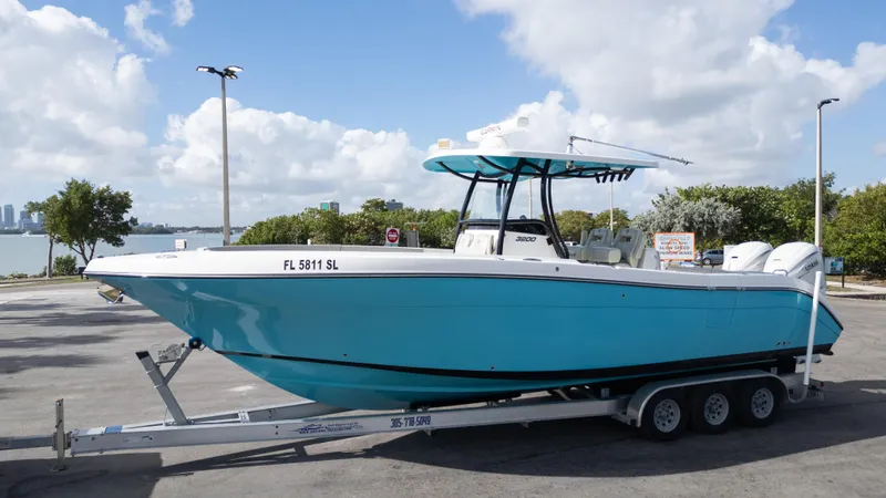 Slide: The Image of 2019 Century 3200 Center Console boat on trailer, parked near waterfront. - 42
