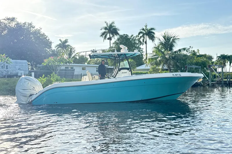 Slide: The Image of 2019 Century 3200 Center Console boat on water, surrounded by tropical trees. - 48