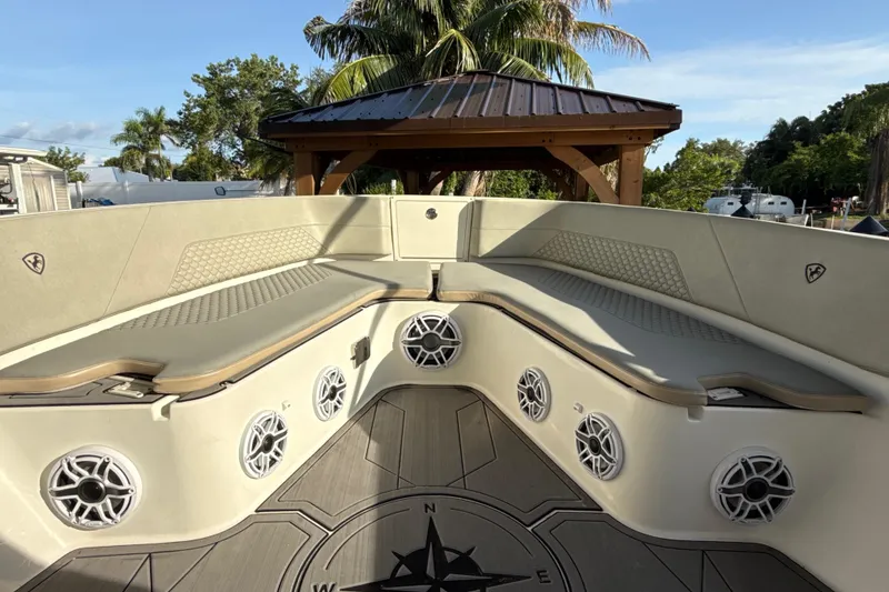 Slide: The Image of 2019 Century 3200 Center Console boat interior with cushioned seating and speaker system. - 50