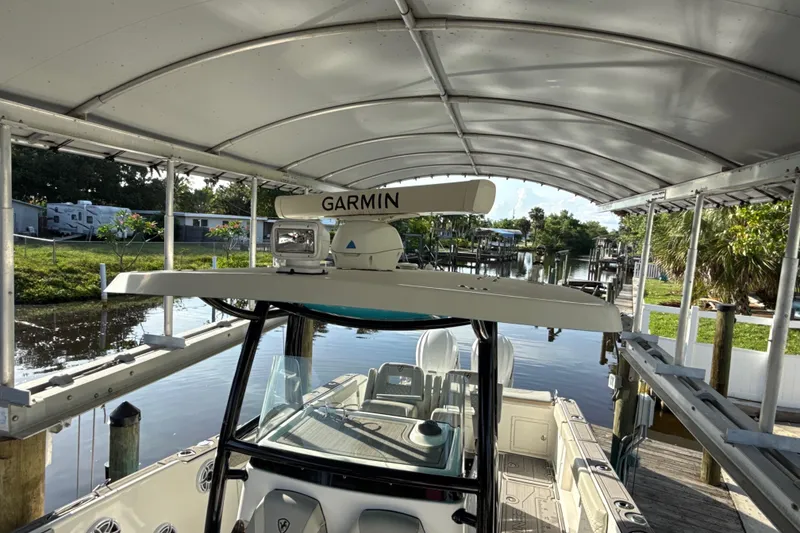 Slide: The Image of 2019 Century 3200 Center Console boat with Garmin radar, docked under a canopy. - 51