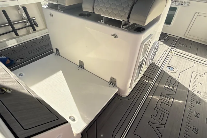 Slide: The Image of 2019 Century 3200 Center Console boat interior with seating and branded flooring. - 52