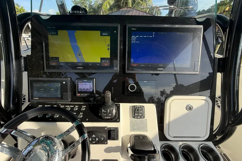 Slide: The Image of Center console of a 2019 Century 3200 boat with Garmin navigation displays. - 55