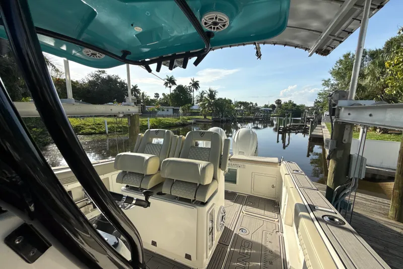 Slide: The Image of 2019 Century 3200 Center Console boat interior at a scenic dockside location. - 63