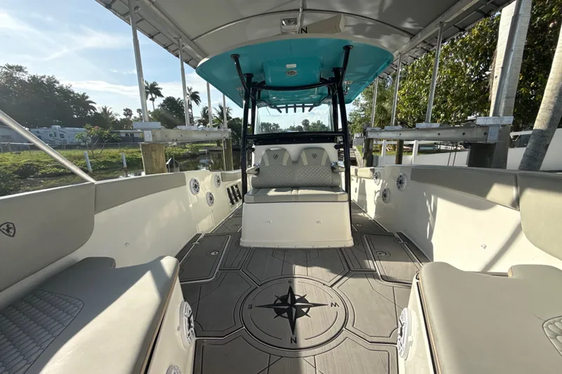 Slide: The Image of 2019 Century 3200 Center Console boat interior with seating and compass design flooring. - 66