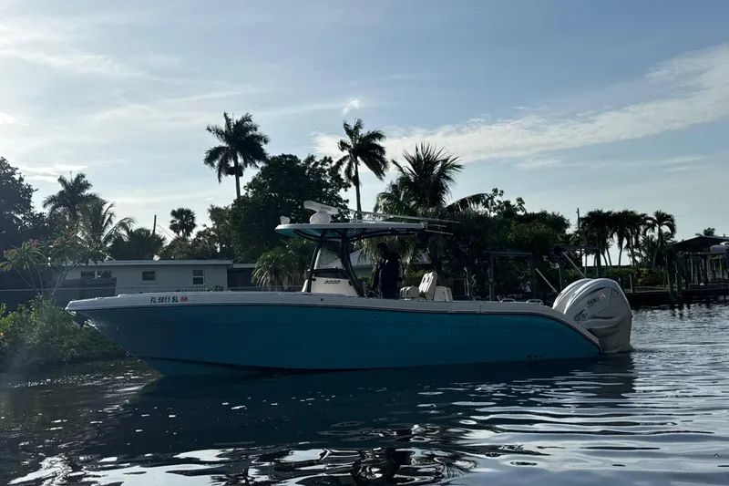 Slide: The Image of 2019 Century 3200 Center Console boat on calm water with palm trees in the background. - 68