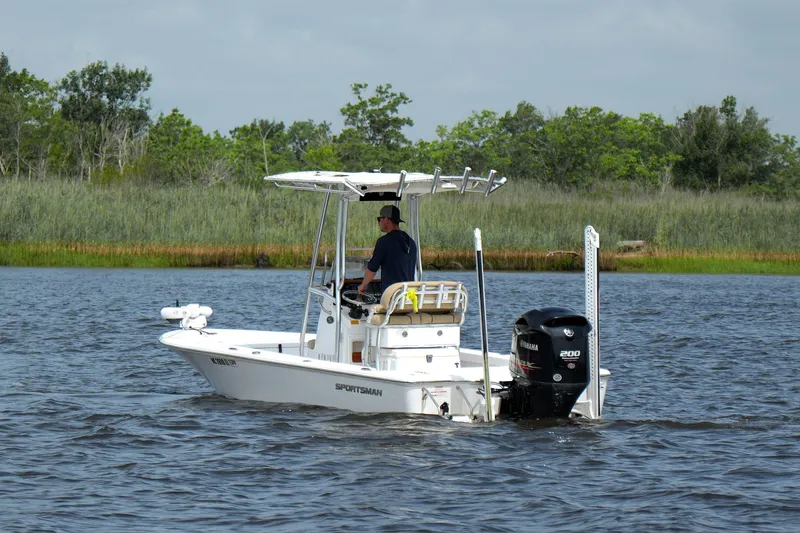 Slide: The Image of 2018 Sportsman Tournament 214 Bay Boat cruising on a scenic river. - 2