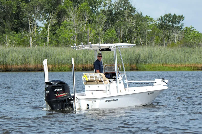 Slide: The Image of 2018 Sportsman Tournament 214 Bay Boat on a calm river with lush greenery. - 5