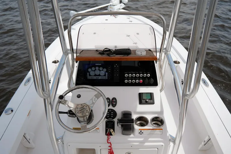 Slide: The Image of 2018 Sportsman Tournament 214 Bay Boat dashboard with steering wheel and control panel. - 9