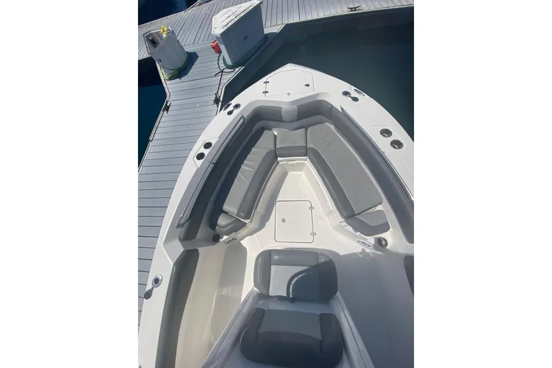 Slide: The Image of 2023 NauticStar 242L Offshore boat with spacious seating at dock. - 16