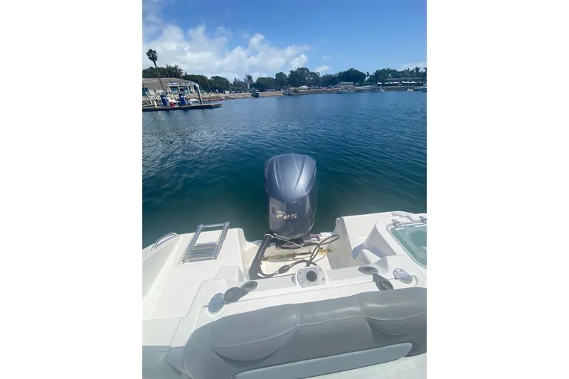 Slide: The Image of 2023 NauticStar 242L Offshore boat with 225 horsepower engine on a serene lake. - 17