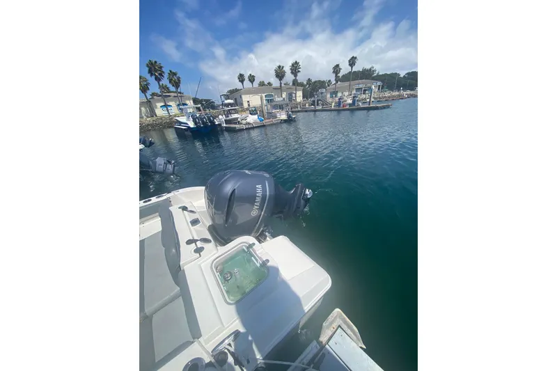 Slide: The Image of 2023 NauticStar 242L Offshore boat with Yamaha engine docked at marina. - 19