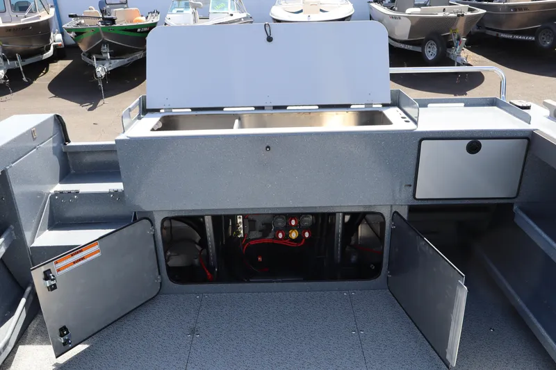 Slide: The Image of 2026 KingFisher 2825 Coastal Express boat interior with open storage compartments and sink. - 11