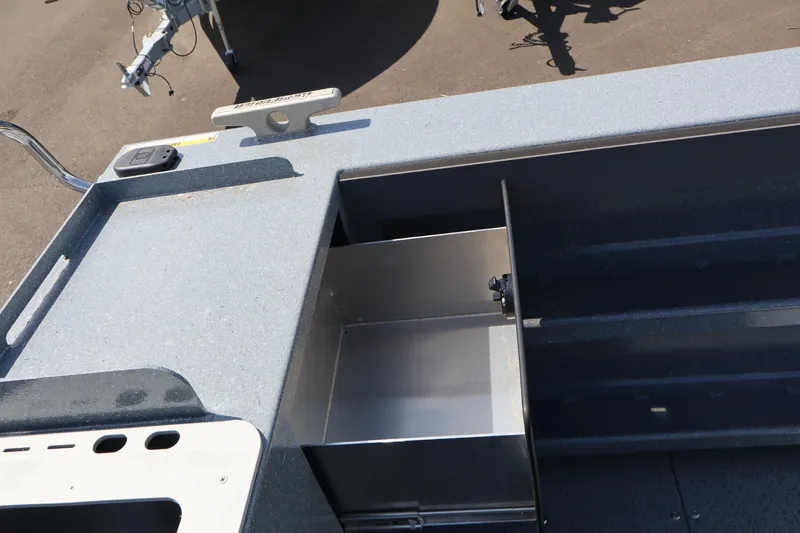 Slide: The Image of KingFisher 2825 Coastal Express 2026 boat interior with storage compartment and control panel. - 12