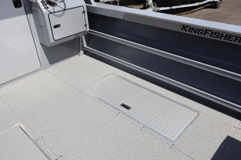 Slide: The Image of 2026 KingFisher 2825 Coastal Express boat interior with storage compartment and control panel. - 15