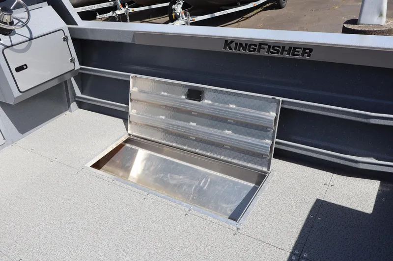 Slide: The Image of 2026 KingFisher 2825 Coastal Express boat interior with open storage compartment. - 16